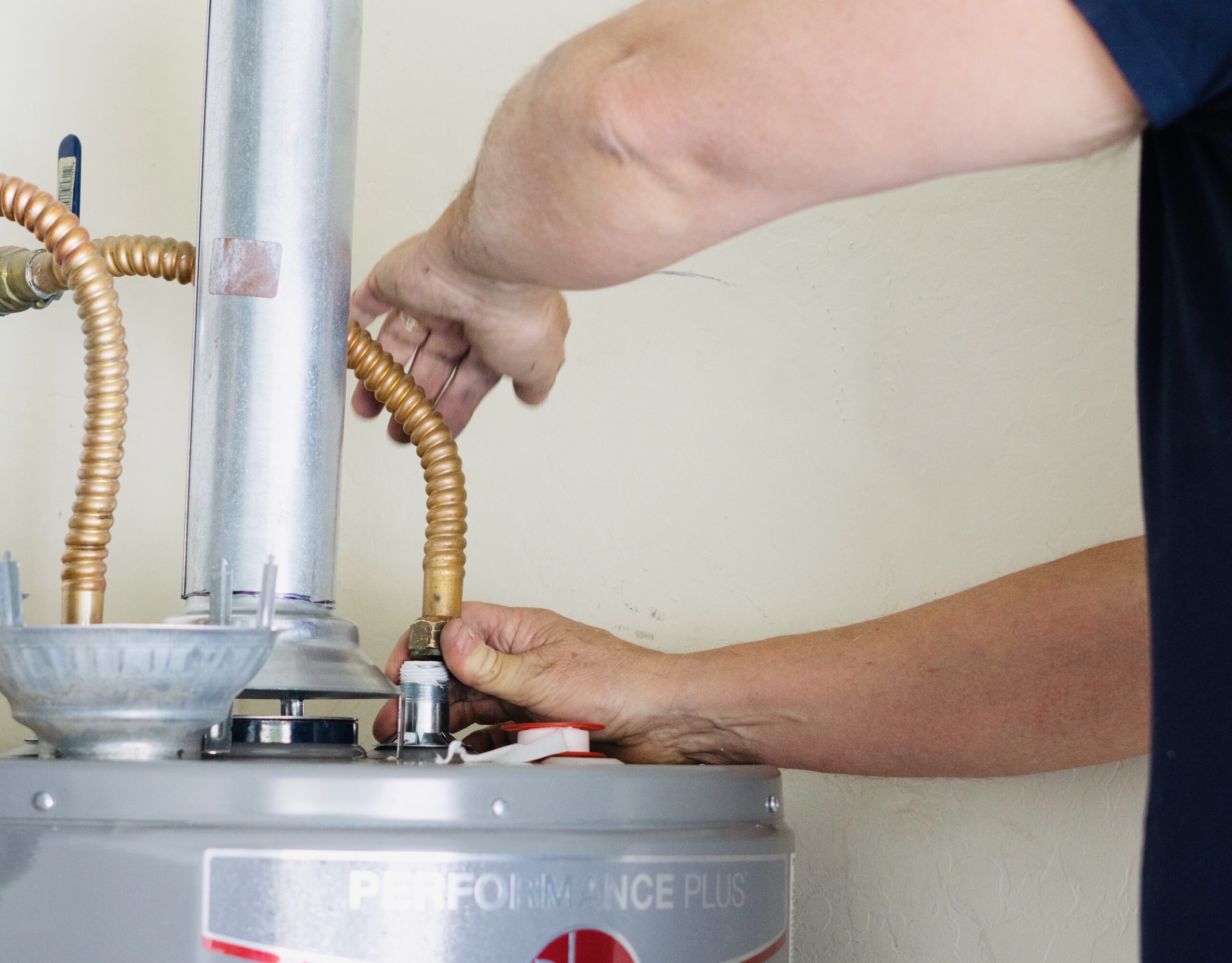 plumber-making-adjustments-and-tightening-water-heater-2025-01-10-22-32-06-utc